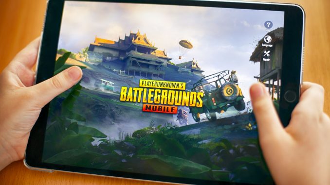 Tambov, Russian Federation - November 23, 2018 Teenager going to play PlayerUnknown's Battlegrounds (PUBG) Mobile mobile game on iPad