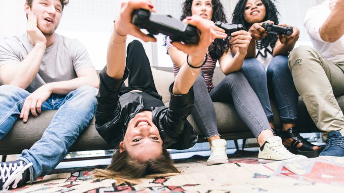 Group of friends playing hard with video games.